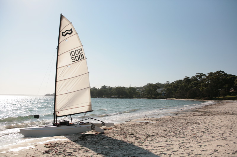 Vincentia, NSW, Sailboat on a sandy beach by the bay
