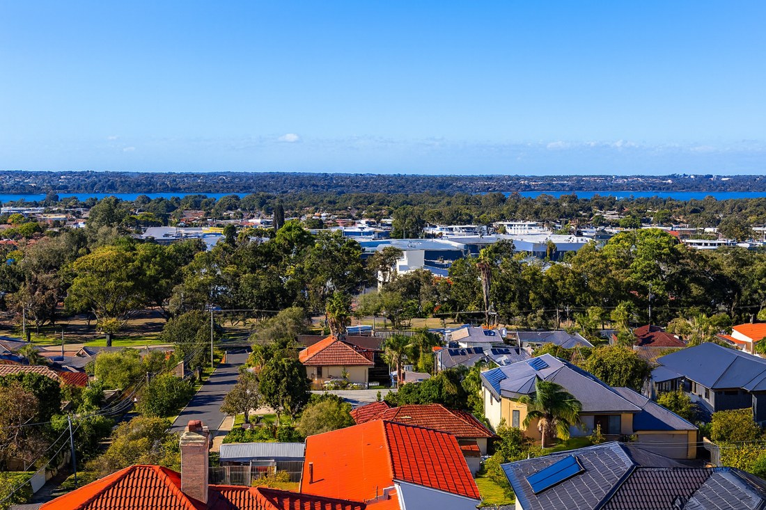 Wanneroo, WA, Houses with roofs overlooking trees and water