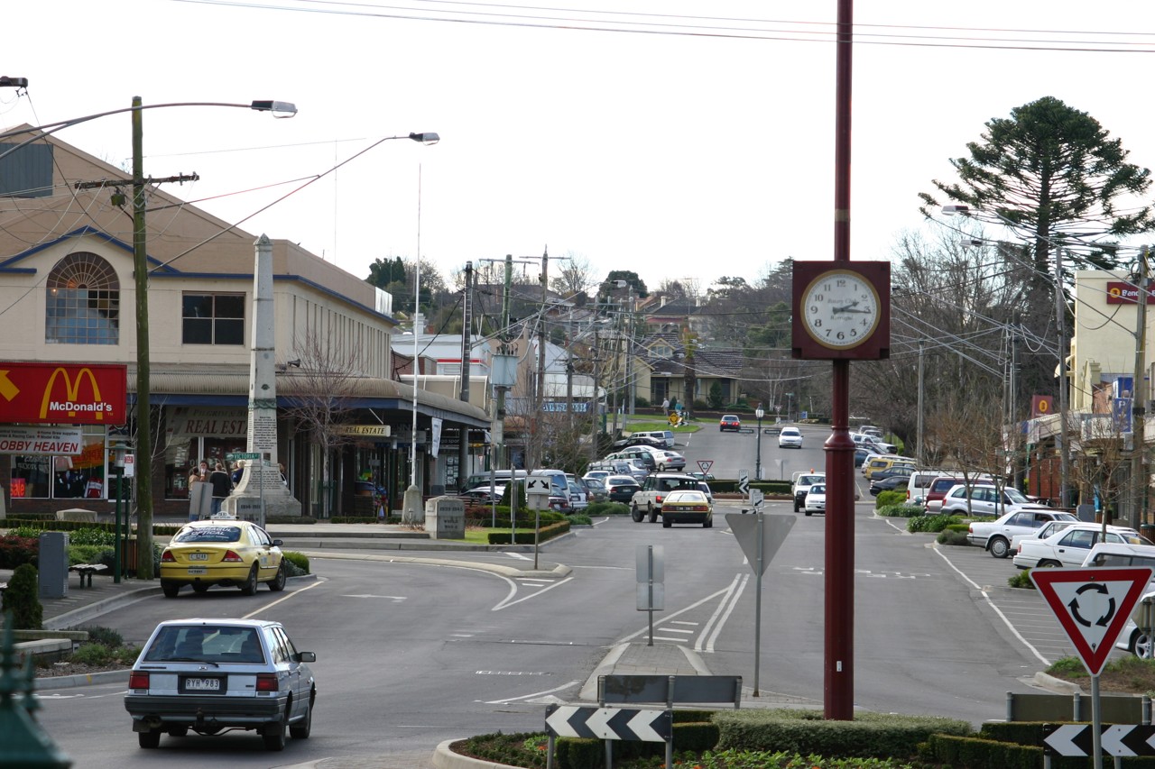Warragul, VIC, Clocktower on a street with shops and cars