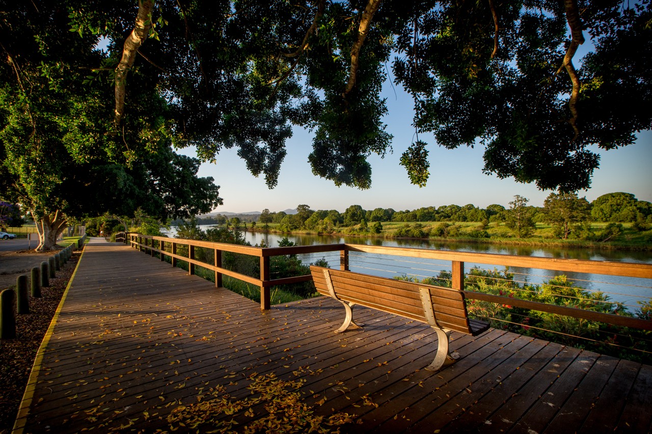 Wauchope, NSW, Riverside boardwalk with bench and trees