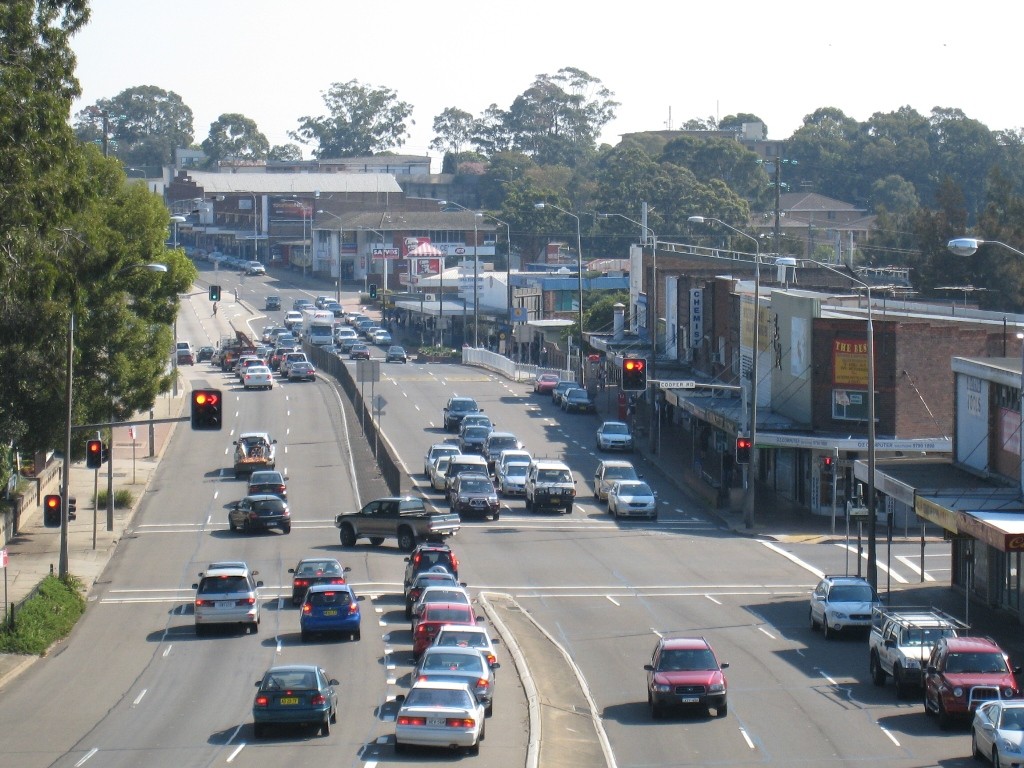 Yagoona, NSW, Busy road intersection with shops and traffic