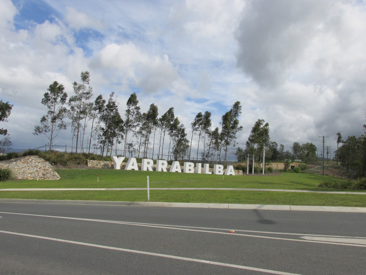 Yarrabilba, QLD, Yarrabilba sign with trees and road