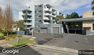 Street-level exterior of the Epping Park apartment complex, with stacked balconies and shared vehicle access. This is the building exterior, not a view inside Unit 371.